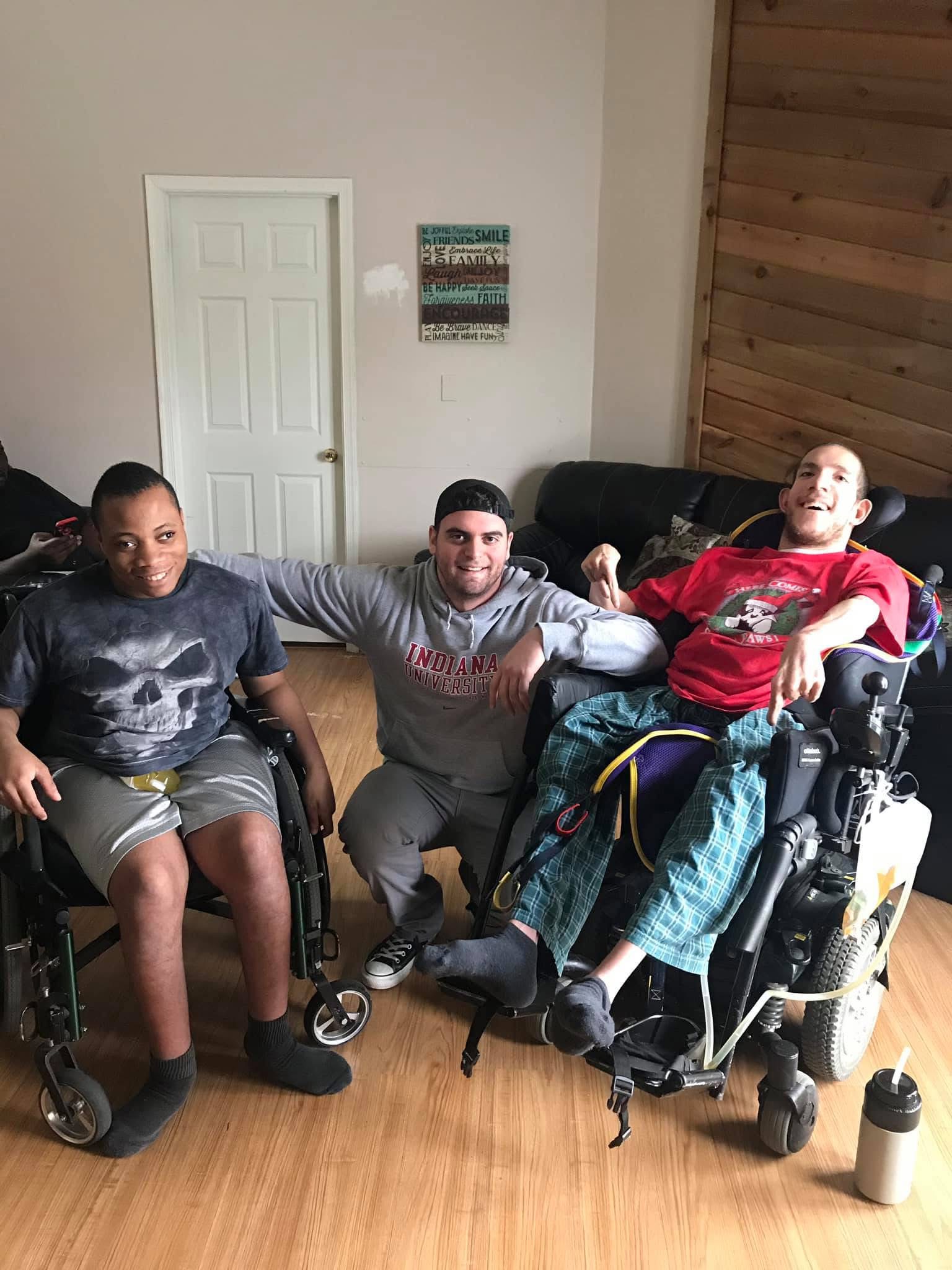 Josh Brown posing with teammates in wheelchairs
