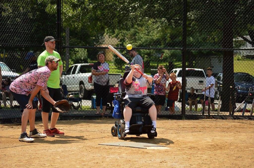 Wheelchair baseball player swinging bat