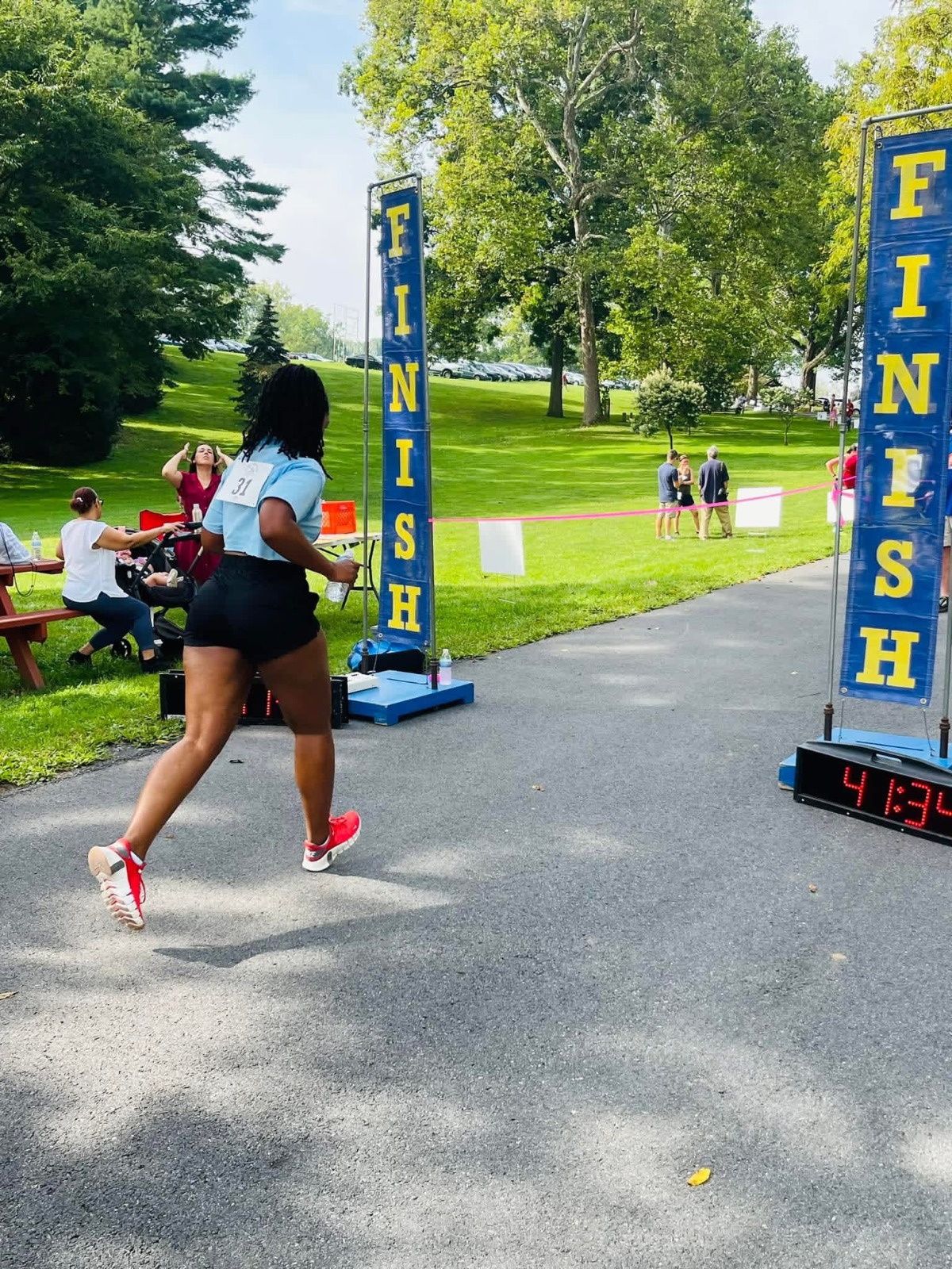 Runner crossing finish line at community race